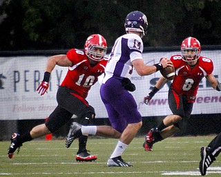 MADELYN P. HASTINGS | THE VINDICATOR..YSU's Ali Cheaib (10) and Donald D'Alesio (8) watch to tackle Western Illinois' Trenton Norvell (14) during Youngstown's homecoming game on October 19, 2013..... - -30-..