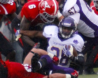 MADELYN P. HASTINGS | THE VINDICATOR..YSU's Travis Williams (6) and Kyle Sirl (33) tackle Western Illinois' J.C. Baker (38) during Youngstown's homecoming game on October 19, 2013.... - -30-..