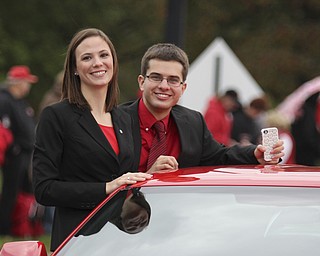 Youngstown State Student Governent representatives Catey Carney (left) and Michael Slavens ride in a car during the Homecoming parade on Fifth Ave. in Youngstown on Saturday. Dustin Livesay  |  The Vindicator 10/19/13  Youngstown.