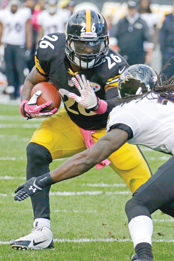 Ravens cornerback Lardarius Webb tries to stop Steelers running back Le’Veon Bell during Sunday’s game at Heinz Field in Pittsburgh. Bell ran for a season-high 93 yards on 19 carries in Pittsburgh’s 19-16 win over Baltimore. 
