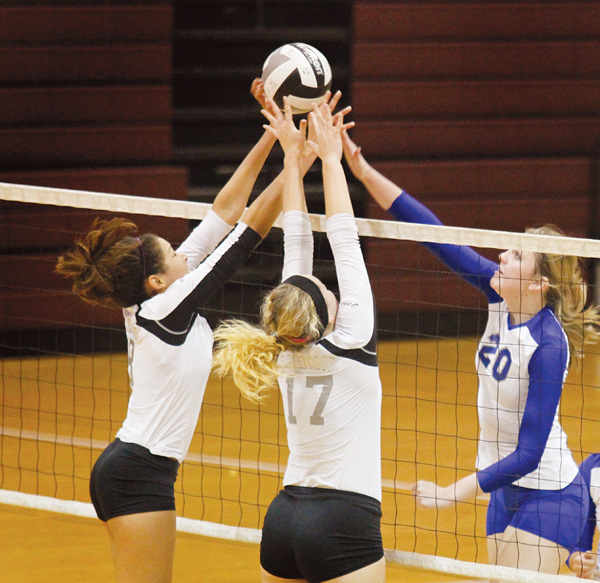 Hubbard’s Kaylyn Garrett (20) attempts a spike as Crestwood’s Taylor Atkins (8) and Morgan Strenk (17) block it during a Division II district semifinal at Boardman High School. Crestwood won in three games, 25-23, 25-14 and 25-19.