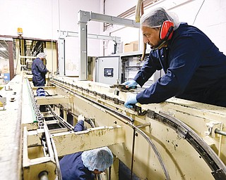 Technicians work to repair machinery at Madelaine Chocolates recently in the Queens borough of New York. Madelaine Chocolates, which was damaged during superstorm Sandy, has partially recovered and repairs are continuing at the factory.