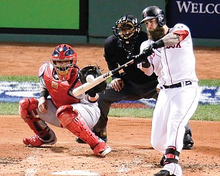 Cardinals catcher Yadier Molina and home plate umpire John Hirschbeck of Poland watch as the Red Sox’s Mike Napoli connects for a three-run double in the first inning of Game 1 of World Series on Wednesday at Fenway Park in Boston. The Red Sox routed the Cardinals, 8-1, to take a one-game lead in the series.