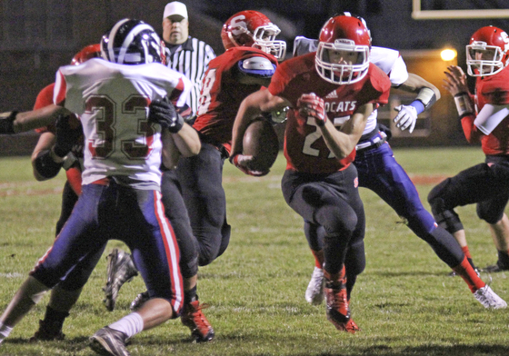 Luke Witkowski (27) of Struthers picks up good blocking on Niles McKinley's Antonio Sollito (33) as he cuts through the Red Dragons defense during the first quarter of Friday nights matchup at Struthers High School.  Dustin Livesay  |  The Vindicator 10/25/13  Struthers High School.