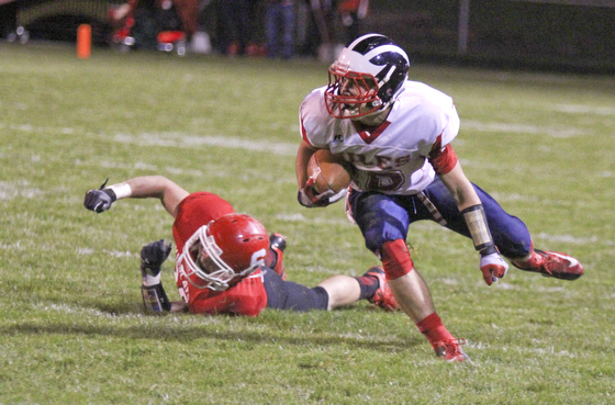 Niles McKinley's Chris Parry (10) keeps his balance after shedding a tackle by Marcus Donnadio (20) of Struthers during the first quarter of Friday nights matchup at Struthers High School.  Dustin Livesay  |  The Vindicator 10/25/13  Struthers High School.
