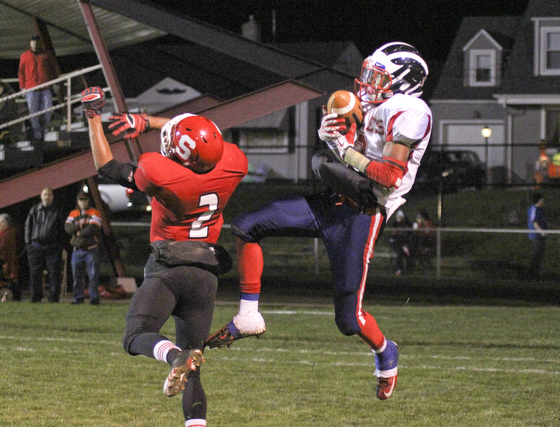 Niles McKinley's Marcus Hill (2) catches a touchdown pass over Frankie Serrano (2) of Struthers during the second quarter of Friday nights matchup at Struthers High School.  Dustin Livesay  |  The Vindicator 10/25/13  Struthers High School.