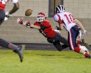 Dalton Moore (3) of Struthers stretches out in an attempt to catch a pass while being defended by Chris Parry (10) of Niles McKinley during the second quarter of Friday nights matchup at Struthers High School.  Dustin Livesay  |  The Vindicator 10/25/13  Struthers High School.