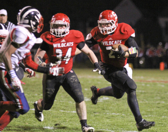 Nick Pollifrone (21) of Struthers picks up a block by Jay King (34) to get the corner on the Niles McKinley defense during the second quarter of Friday nights matchup at Struthers High School.  Dustin Livesay  |  The Vindicator 10/25/13  Struthers High School.