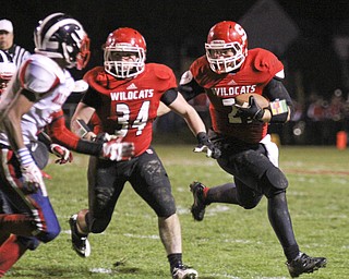 Nick Pollifrone (21) of Struthers picks up a block by Jay King (34) to get the corner on the Niles McKinley defense during the second quarter of Friday nights matchup at Struthers High School.  Dustin Livesay  |  The Vindicator 10/25/13  Struthers High School.