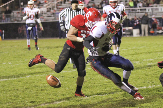 Marcus Donnadio (20) of Struthers forces a fumble by Corey Hayes (36) of Nile McKinley to stall a late second quarter drive keeping a Wildcat lead at halftime of 21-7 during the second quarter of Friday nights matchup at Struthers High School.  Dustin Livesay  |  The Vindicator 10/25/13  Struthers High School..