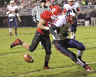Marcus Donnadio (20) of Struthers forces a fumble by Corey Hayes (36) of Nile McKinley to stall a late second quarter drive keeping a Wildcat lead at halftime of 21-7 during the second quarter of Friday nights matchup at Struthers High School.  Dustin Livesay  |  The Vindicator 10/25/13  Struthers High School..