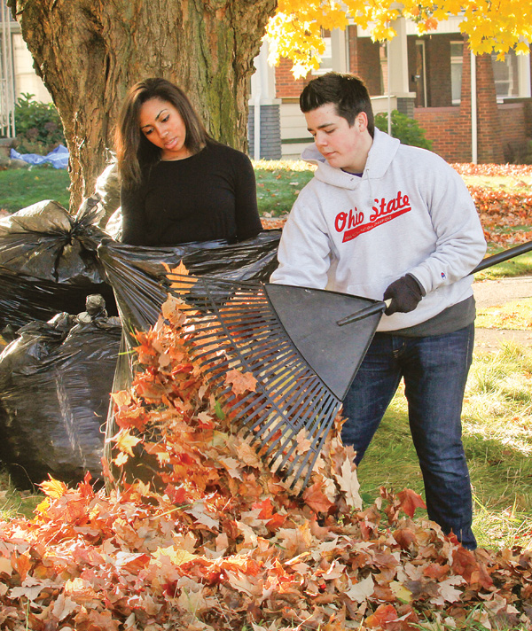 Natalia Mahdee, a Youngstown Christian School sophomore, and Perry Chickonoski, a senior, bag leaves Monday at homes in the neighborhood surrounding the school as part of a service project.