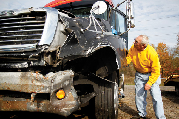 Charles Jungfleisch of Georgetown, Pa., examines a semi tractor that was for sale in a Monday surplus-vehicle auction after it had been forfeited to the Mahoning County Prosecutor’s Office as restitution by a Las Vegas truck driver who rammed it into an Austintown nightclub. The highest bid for it was $6,500.