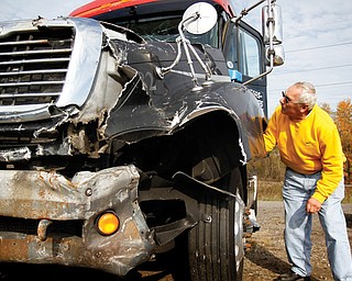 Charles Jungfleisch of Georgetown, Pa., examines a semi tractor that was for sale in a Monday surplus-vehicle auction after it had been forfeited to the Mahoning County Prosecutor’s Office as restitution by a Las Vegas truck driver who rammed it into an Austintown nightclub. The highest bid for it was $6,500.