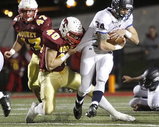 . ROBERT K. YOSAY | THE VINDICATOR..Fitch #34 Sam Ortz gets jerey tackled by mooney #40 Andrew Armstrong and #47 Nick Huber t looks on..Austintown Fitch @ Mooney at Stambaugh Stadium