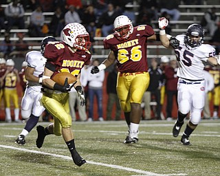 . ROBERT K. YOSAY | THE VINDICATOR..#22 Mooney Mark Handel takes off for the sidelines and a gain as mooneys #66 Ted Everett holds back #5 Fitch KerrrellJohnson..Austintown Fitch @ Mooney at Stambaugh Stadium