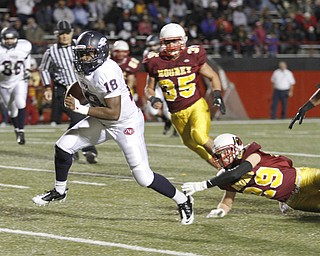 . ROBERT K. YOSAY | THE VINDICATOR..Sliping away for seting up a TD is QB #18 Antwan Harris as he leaves Behind #29 Mooney Joey Kleeh and #35 Anthony Dermotta -.Austintown Fitch @ Mooney at Stambaugh Stadium