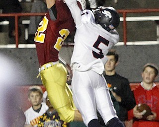 . ROBERT K. YOSAY | THE VINDICATOR..Mark Handel gets a ball deflected by # 5 Fitch Kerrell Johnson to break up the play ..during third quarter action..Austintown Fitch @ Mooney at Stambaugh Stadium