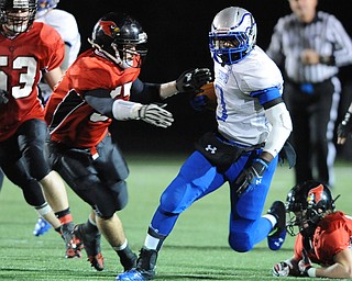 Hubbard #1 Darnell Tate runs the football before being hit by Canfield #57 Alex Heldreth during the 1st quarter of Friday nights game.