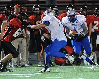 Hubbard #4 George Hill runs inside the block of teammate #72 Jared O'Hara on Canfield #66 Jacob Esarco during the 1st quarter of Friday nights game.