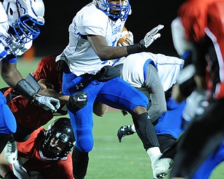 Hubbard #1 Darnell Tate while trying to break the tackle of Canfield #25 Bryan Batton during the 1st quarter of Friday nights game.