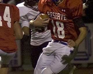 Kelli Cardinal/The Vindicator .Western Reserve quarterback Nick Allison carries the ball Friday night against Wellsville defenders on the Blue Devils field in Berlin Center.