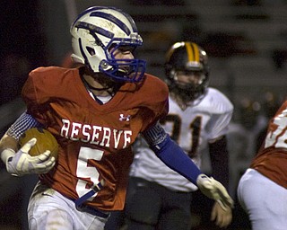 Kelli Cardinal/The Vindicator .Western Reserve wide receiver Danny Rosati carries the ball Friday night against Wellsville defenders on the Blue Devils field in Berlin Center.
