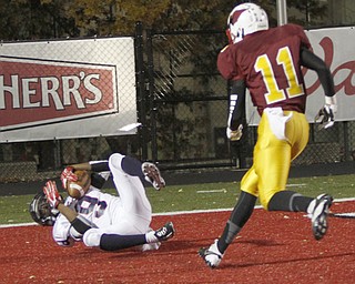. ROBERT K. YOSAY | THE VINDICATOR..#9 Fitch Joey Harrington brings in a TD pass during second quarter action - as #11 Mooney Roosevelt Cooper looks on ..Austintown Fitch @ Mooney at Stambaugh Stadium