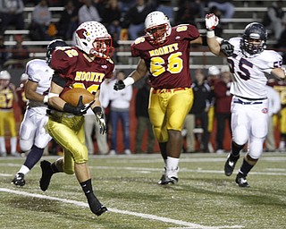 . ROBERT K. YOSAY | THE VINDICATOR..#22 Mooney Mark Handel takes off for the sidelines and a gain as mooneys #66 Ted Everett holds back #5 Fitch KerrrellJohnson..Austintown Fitch @ Mooney at Stambaugh Stadium