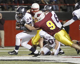 . ROBERT K. YOSAY | THE VINDICATOR..Fitchs #24 Darrin Hall blast through the line as Mooneys #9 Christian Lowery as Mooneys #29 Joey Kleeh lines up to bring him down ..during second quarter action..Austintown Fitch @ Mooney at Stambaugh Stadium