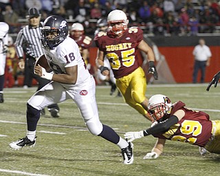 . ROBERT K. YOSAY | THE VINDICATOR..Sliping away for seting up a TD is QB #18 Antwan Harris as he leaves Behind #29 Mooney Joey Kleeh and #35 Anthony Dermotta -.Austintown Fitch @ Mooney at Stambaugh Stadium