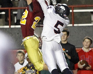 . ROBERT K. YOSAY | THE VINDICATOR..Mark Handel gets a ball deflected by # 5 Fitch Kerrell Johnson to break up the play ..during third quarter action..Austintown Fitch @ Mooney at Stambaugh Stadium