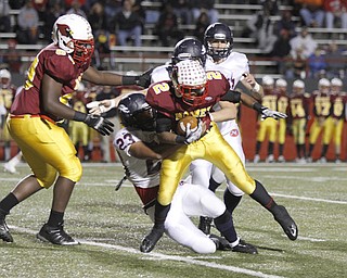 . ROBERT K. YOSAY | THE VINDICATOR..Mooneys #2 C JAmill is caught at the ine by Fitch #23 Damien Gray - as Mooney #69 Tyrell Rodgers looks on during second quarter action..Austintown Fitch @ Mooney at Stambaugh Stadium