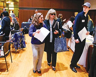 Maura Mazzocca attends a job fair for the visually impaired with the aid of volunteer guide Kate Loosian, left, at Radcliffe Yard in Cambridge, Mass., recently. The blind must overcome many hurdles in pursuit of full-time work.