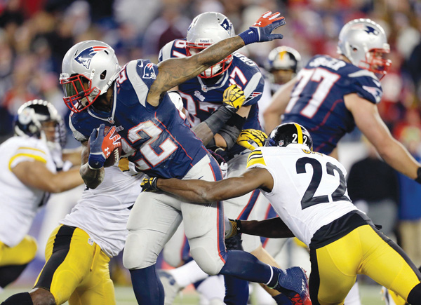 Patriots running back Stevan Ridley (22) tries to get away from Steelers cornerback William Gay (22) in the fourth quarter of Sunday’s game in Foxborough, Mass. The Patriots won, 55-31.