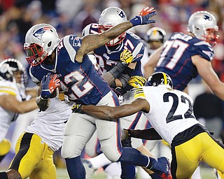 Patriots running back Stevan Ridley (22) tries to get away from Steelers cornerback William Gay (22) in the fourth quarter of Sunday’s game in Foxborough, Mass. The Patriots won, 55-31.