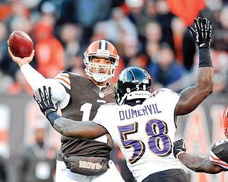 Cleveland Browns quarterback Jason Campbell throws a 1-yard touchdown pass over Baltimore Ravens linebacker
Elvis Dumervil (58) in the first quarter of a game Sunday in Cleveland.