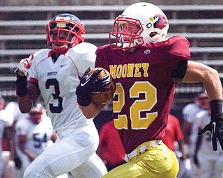 Cardinal Mooney running back Mark Handel races with Imhotep Charter defender Nyeem Thrones during a game Aug. 31 at Stambaugh Stadium. The Cardinals lost the game 49-21, but have earned a spot in the postseason thanks to a 6-4 record.