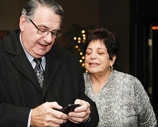 MADELYN P. HASTINGS I THE VINDICATOR..Ken and his wife Linda Carano looks at election results during their election party at Rachel's in Austintown on November 5, 2013.