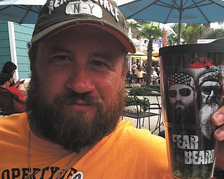 Leslie Meehan: "My husband Carl Meehan loves his beard! He started growing it after Christmas last year. The picture is from our vacation to Florida in June, and, of course, he is carrying his "Fear the Beard" cup of sweet tea!