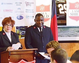 Salvation Army Majors Valerie and Elijah O. Kahn, Mahoning County area services coordinators, introduce the keynote speaker, Gary Meszaros, owner of Quaker Steak & Lube in Boardman, during Thursday’s 2013 Red Kettle Campaign kickoff breakfast. The kettles and bell ringers will be at area shopping centers beginning Monday .