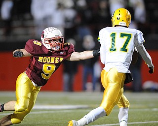 John Hay quarterback #17 Mylik Mitchell is pressured by Mooney #9 Christian Lowery during the 3rd quarter of Friday nights game.