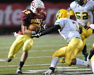 Mooney #22 Mark Handel runs the football while John Hay #3 Latif Hughes goes for the tackle during the 3rd quarter of Friday nights game.