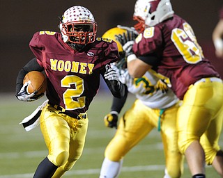 Mooney #2 C.J. Amill runs the football behind the block of offensive linemen #68 Zach Dundics on John Hay #3 Latif Hughes during the 3rd quarter of Friday nights game.