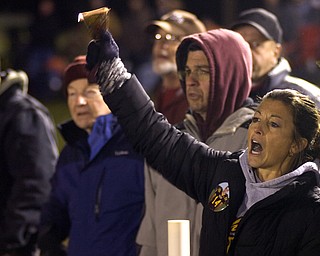 Kelli Cardinal/The Vindicator .Dacia (ok) Allen cheers for the Raiders and her son, South Range player Bryce Allen, during the first half in Friday night in their game against Cuyahoga Heights at Memorial Field in North Lima.