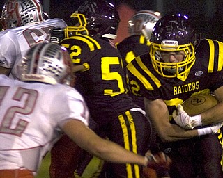 Kelli Cardinal/The Vindicator .South Range running back Billy Goodall carries the ball against Cuyahoga Heights defender Craig McDaniel during the first half Friday night at Memorial Field in North Lima.