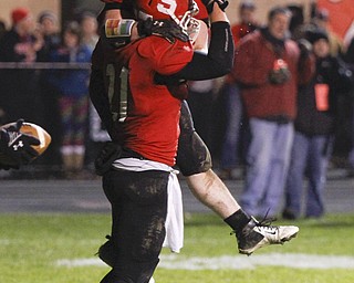 ROBERT K. YOSAY | THE VINDICATOR..Struthers #34 Jay King jumps into Luke Witkowski arms after Luke ran the TD that put struthers ahead in the third quarter and they never looked back... - -30-.......