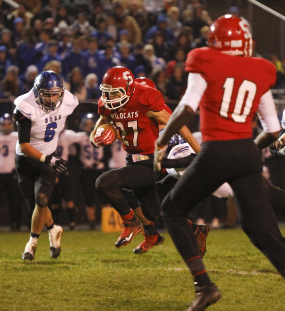        ROBERT K. YOSAY  | THE VINDICATOR...Struthers #27   Luke Witkowski breaks through the line and a first down as Lakeviews #6 Chris Romano and Struthers #10 Temeko Holness look on.. - -30-.......