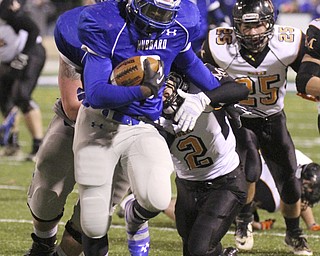 William D. Lewis | The Vindicator .Hubbard's LJ Scott(3 eludes MArlinton defenders Jake Walker) and Steven MAsters (25) during 1rast half action at Hubbard 11-8-13.