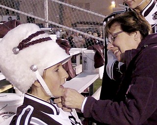 William D LEwis the vindicator Beth Bean, Boardman Band Booster President helps kaitlin Windt with her band hat before halftime show.